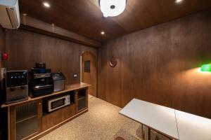 a room with a kitchen with a table and a microwave at Life in Cheonggye in Seoul