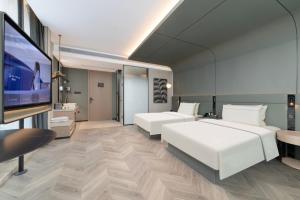 Postel nebo postele na pokoji v ubytování Atour Hotel Hubei Provincial Museum East Lake