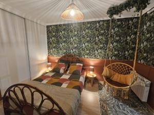 a bedroom with a bed and a swing at TropiKana in Evry-Courcouronnes