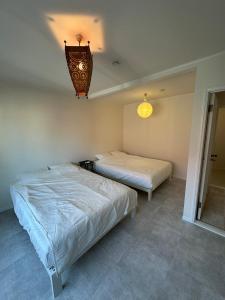 Postel nebo postele na pokoji v ubytování Guest House Chigasaki