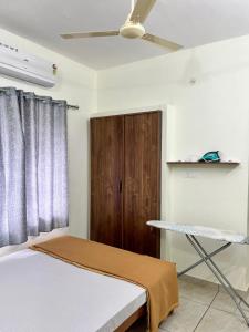 a bedroom with a bed and a wooden door at Ayat Apartments - near to Rajagiri Hospital in Alwaye
