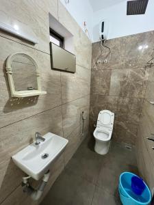 a bathroom with a sink and a toilet at Ayat Apartments - near to Rajagiri Hospital in Alwaye
