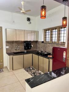 a kitchen with a counter and a stove top oven at Ayat Apartments - near to Rajagiri Hospital in Alwaye