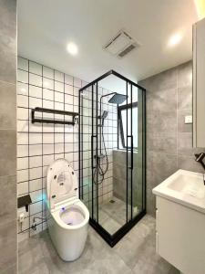 a bathroom with a toilet and a shower and a sink at Urban Hub Bund Art Deco 3Bedroom Enjoy the View of Shanghai with Balcony in Shanghai