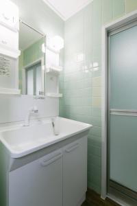 a bathroom with a sink and a mirror at Naha - House / Vacation STAY 79997 in Naha