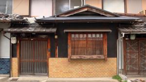a brick house with three gates on the front of it at Kyoto - House / Vacation STAY 80314 in Kyoto
