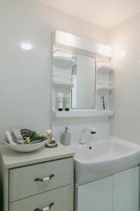 a white bathroom with a sink and a mirror at Uruma - House / Vacation STAY 7480 in Uruma