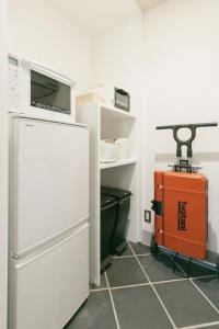 a kitchen with a white refrigerator and an orange cart at Kunigami-gun - House / Vacation STAY 80725 in Onna