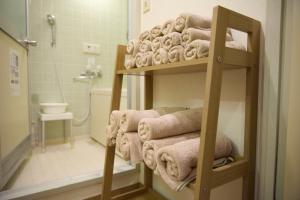 a bathroom with a bunch of towels on shelves at Maison Etoile 706 / Vacation STAY 7561 in Nagoya