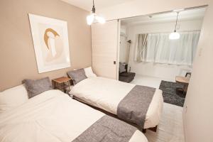 札幌市にあるPremiere N21 - Vacation STAY 13906のベッド2台と鏡のある寝室