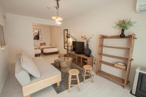 a living room with a couch and a tv at Premiere N21 / Vacation STAY 7450 in Sapporo