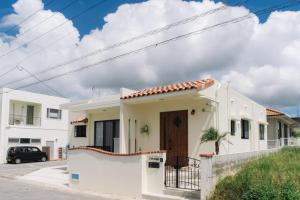 a white house with a gate and a fence at Nakagami-gun - House / Vacation STAY 80729 in Jima