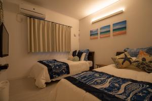 a room with two beds and a window at Nakagami-gun - House / Vacation STAY 80729 in Jima