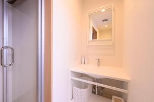 a bathroom with a sink and a mirror at BEYOND HOTEL Takayama 3rd - Vacation STAY 82215 in Takayama