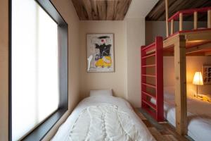 a bedroom with two bunk beds and a window at BEYOND HOTEL Takayama 2nd - Vacation STAY 82239 in Takayama
