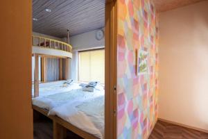 a bedroom with a large bed in a room at BEYOND HOTEL Takayama 2nd - Vacation STAY 82239 in Takayama