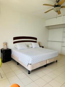 a bedroom with a bed and a ceiling fan at Tikal Sunrise House in Flores