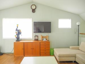 a living room with a couch and a clock on the wall at Nasu-gun - House - Vacation STAY 7648 in Nasu