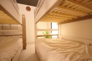 a bedroom with two bunk beds and a window at Minamitsuru-gun - House - Vacation STAY 82298 in Fujikawaguchiko