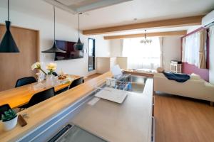 a kitchen and living room with a table and a couch at Minamitsuru-gun - House - Vacation STAY 82353 in Fujikawaguchiko