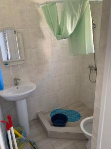 a bathroom with a sink and a toilet and a shower at Aquamarine in Zatoka