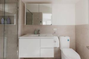 a bathroom with a toilet and a sink and a mirror at Kelly Street Cottage in Historic Battery Point in Hobart +26 photos