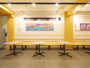 a room with tables and paintings on the wall at RetroSpect Stay Yokohama - Vacation STAY 99047v in Yokohama