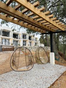 Dos cestas de metal colocadas bajo una pérgola en Casa Madera 1C, en Zacatlán