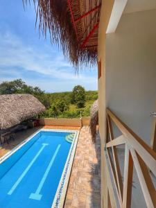 a swimming pool with a view of a villa at LA VICTORIA Casa tropical con piscina privada in Carmen de Apicalá