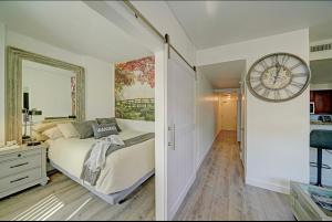 a bedroom with a bed and a large clock on the wall at Amazing Condo Heart of San Diego in San Diego