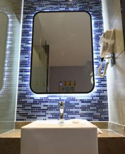 a bathroom with a sink and a mirror at Shell Hotel Shanghai Normal University Hongcao Road Metro Station Guiping Road in Shanghai