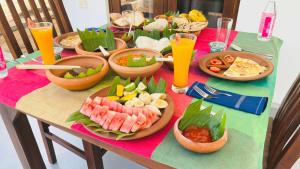 a table with bowls of food and plates of food at Beach Resort Paradise Bungalows in Trincomalee