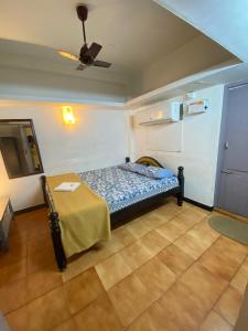 a room with a bed and a table in it at La Ruelle Guest House in Puducherry