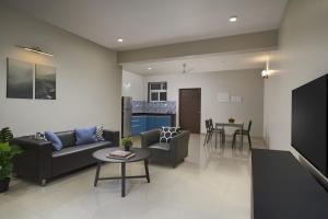a living room with a couch and a table at Paprika Stays Panjim Donapaula in Panaji