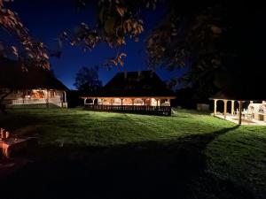 a large building on a field at night at Copacis Country Home in Breb