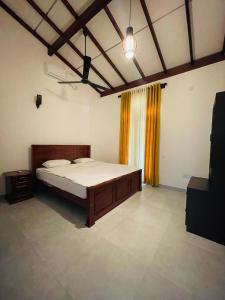 a bedroom with a bed and a television in it at Yala Safari Rest in Tissamaharama