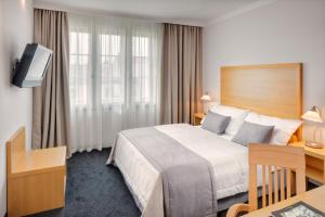 Voodi või voodid majutusasutuse Hotel Clement toas