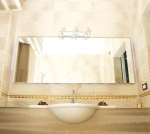 a bathroom with a white sink in front of a window at Apartment at Milsa Nasr City, Building No. 35 in Cairo