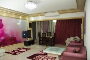 a living room with pink furniture and a dining room at Apartment at Milsa Nasr City, Building No. 35 in Cairo