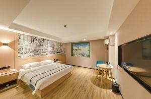 a hotel room with a large bed and a table at City Comfort Inn Beijing Capital Airport Shunyi Metro Station in Beijing