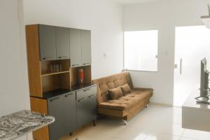 a living room with a couch and a kitchen at Casa de praia Sales Bahia in Valença