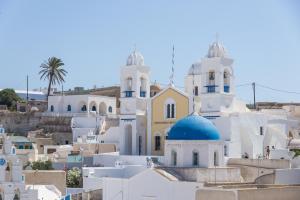 a group of white buildings with blue domes at Villa Aegeon Grande in Megalochori