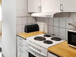 a kitchen with a stove and a counter top at 8 person holiday home in Sollerön in Sollerön +13 photos