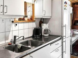 a kitchen with a sink and a refrigerator at 8 person holiday home in Sollerön in Sollerön