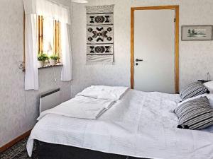 a white bed in a bedroom with a window at 8 person holiday home in Sollerön in Sollerön