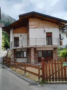 a house with a wooden fence in front of it at Villa Augusta in Auronzo di Cadore