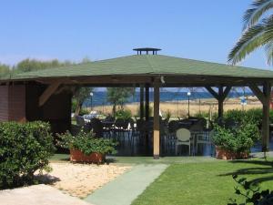 a gazebo with a table and chairs under it at Residence Club Barbara in Ostuni