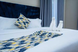 En eller flere senge i et værelse på Imani Guest House