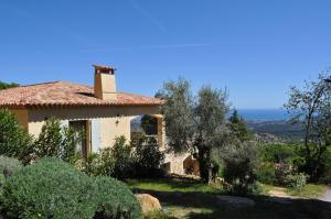 una casa en la cima de una colina con árboles en Les Mas d'Azur Appartement, en Vence