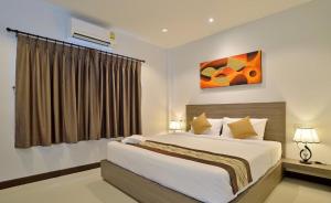 a bedroom with a large bed and a window at The Rich Resort in Krabi town +68 photos